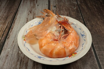 fried shrimps on a plate. Baked large tiger prawn. Famous steamed seafood menu in Asian restaurant.