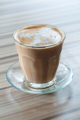 a cup of hot cappuccino coffee with cream