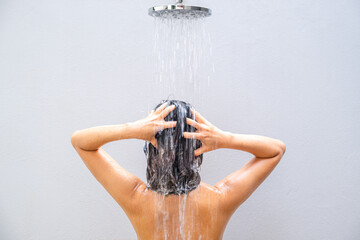 Beautiful woman's hand She was washing her hair and nourishing her scalp. Shampoo and conditioner	
