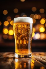 Deurstickers A chilled glass of beer with frothy head, sparkling on a festive background © Виктория Попова