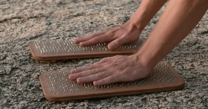 Meditation practice with hands on nail-studded boards close-up Testament to mental resilience in meditation. Integrating physical challenges in meditation practice Harmony of challenge and serenity.