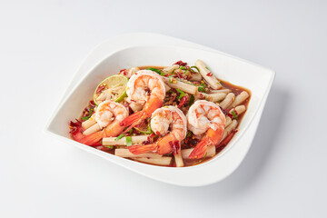 Lotus roots spicy salad with prawns served on a white plate isolated on white background.