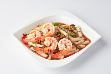 Lotus roots spicy salad with prawns served on a white plate isolated on white background.