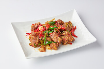 Stir-fried stewed beef shank with holy basil , chili and garlic served on white plate isolated on white background. Stir-fried holy basil is a very popular food in Thailand.