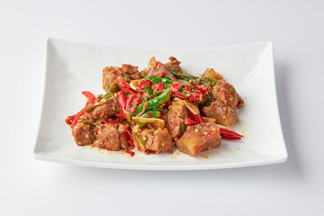 Stir-fried stewed beef shank with holy basil , chili and garlic served on white plate isolated on white background. Stir-fried holy basil is a very popular food in Thailand.