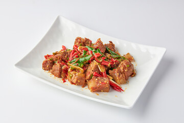 Stir-fried stewed beef shank with holy basil , chili and garlic served on white plate isolated on white background. Stir-fried holy basil is a very popular food in Thailand.