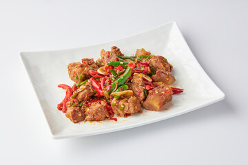 Stir-fried stewed beef shank with holy basil , chili and garlic served on white plate isolated on white background. Stir-fried holy basil is a very popular food in Thailand.