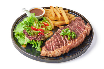 Sliced Grilled picanha steak served with fried french fries, fresh salad, tomatoes and dipping sauce served on a black plate isolated on white background.