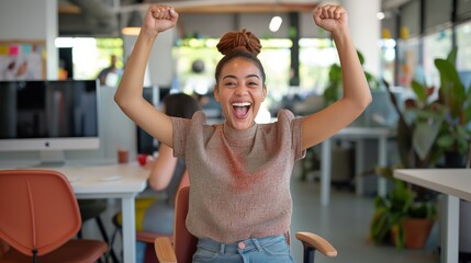 Victorious Entrepreneur, Energetic Young Woman Celebrating Success with Raised Arms, Seated in Office Chair.