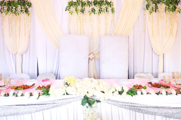 Wedding reception area ready for the reception. gorgeous wedding chair and table setting for fine dining at outdoors.
