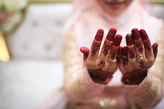 Malaysian wedding bride showing henna designs and jewelry. Close up image.