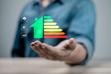 Energy efficiency concept. Businessman holding energy efficiency rating on virtual screen for...