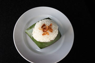 indonesian traditional food steam rice wrap with banana leaf