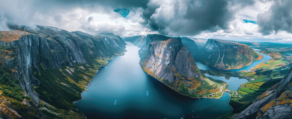 panoramic photo of the fjords in Norway, taken from the top of a mountain with a lake below - obrazy, fototapety, plakaty