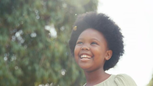 Close up of smiling young girl outdoors in countryside enjoying nature- shot in slow motion