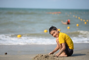 Child and person enjoying beach fun by the sea, playing and fishing in the sand on a sunny summer day - 776737967
