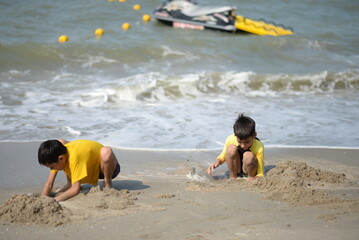 Child and person enjoying beach fun by the sea, playing and fishing in the sand on a sunny summer day - 776737968