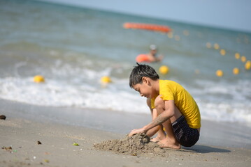 Child and person enjoying beach fun by the sea, playing and fishing in the sand on a sunny summer day - 776738388