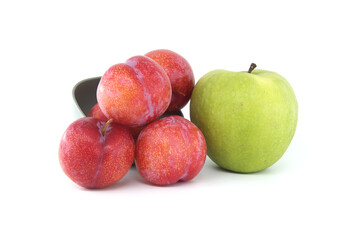 Red plums and green apple isolated on white background