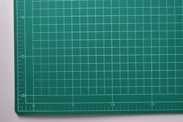 green cutting mat board on white background with line and scale measure guide pattern for object art design, tool equipment of diy craft work