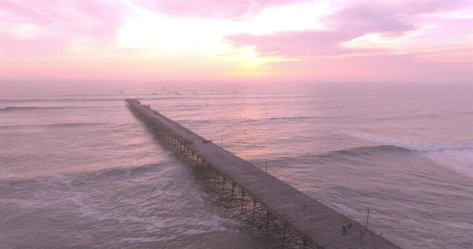 Puerto EtenAerial view of beauty sunset over the sea and dock with artisanal fishermen. Puerto Eten, Peru. 