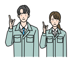 指差しポーズをする作業服姿の男性と女性（上半身）
