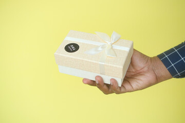  hand putting a thank you sticker on a gift box 