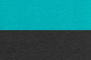 Texture of craft turquoise and black paper background, half two colors, macro. Vintage cerulean...