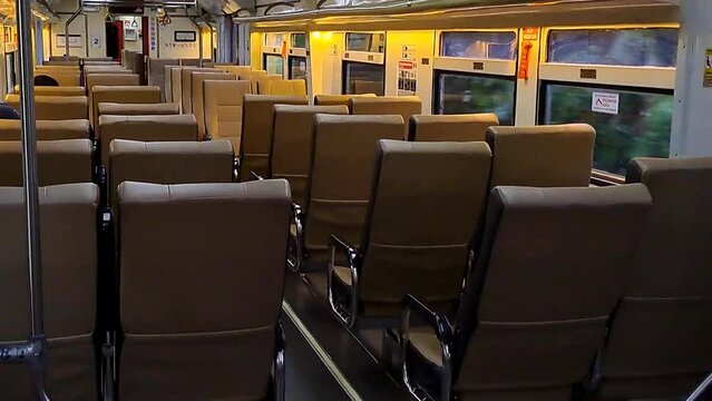 Public trains in Java, Indonesia are empty of passengers when it is almost dark. There were many empty seats on the intercity train and the carriages looked deserted