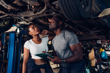 Auto mechanic are checking and repair maintenance auto engine is problems at car repair shop.
