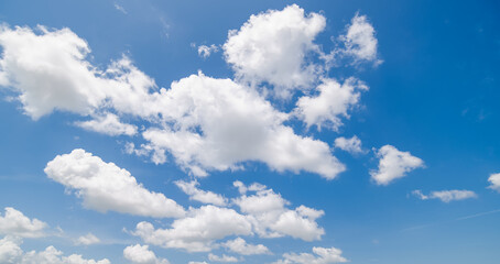 Panoramic view of clear blue sky and clouds, Blue sky background with tiny clouds. White fluffy clouds in the blue sky. Captivating stock photo featuring the mesmerizing beauty of the sky and clouds.