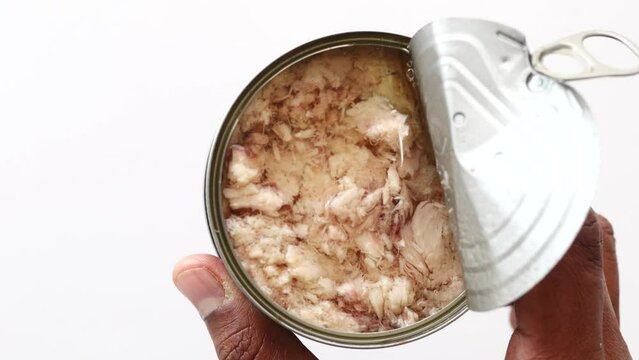 top view of holding a canned tuna 