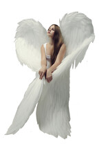 a romantic angel girl in a white bodysuit with white wings poses sitting in a photo studio