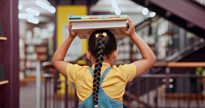 Books, carrying or girl in a library walking for knowledge, growth or development for future learning. Scholarship, education or back of student at school studying information to search for a story