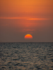 Breathtaking sunset over the serene ocean at Playa Blanca, Baru, Cartagena, Colombia