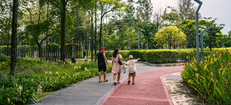 People walking in the Taman Tasik Titiwangsa natural public park in the Kuala Lumpur city, Malaysia