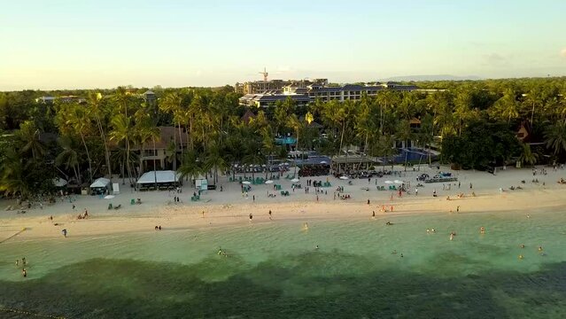 Aerial of Hennan Resort at Alona Beach, in Panglao Island Bohol. Late afternoon with several bancas docked.