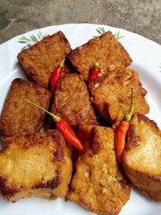 Tahu dan tempe bacem. Bacem tofu and tempeh are boiled with brown sugar and other spices then cooked in a large saucepan. One of the typical Javanese food.