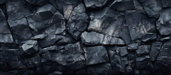 A detailed view of a sturdy rock wall standing out vividly against the contrast of a solid black backdrop.