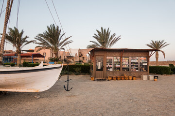 tea shop with a boat at the beach with palm trees