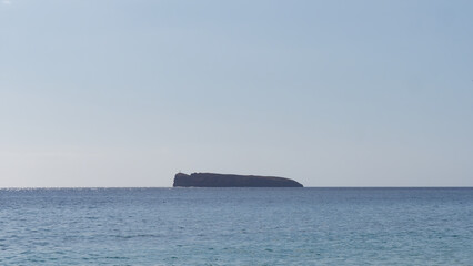 Minimalistic photo of a Molokini Crater with a clear blue sky in the background near the island of Maui, Hawaii USA