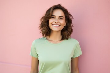 Fototapeta premium A woman with short hair is smiling and wearing a green shirt
