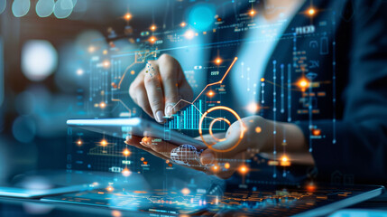 A business professional interacts with a futuristic holographic analytics interface on digital tablet and smartphone..