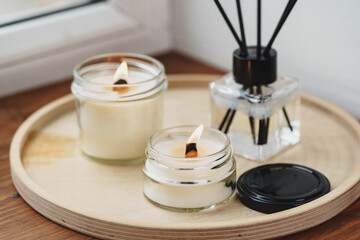 Scented Candles and Diffuser on a Wooden Tray by the Window