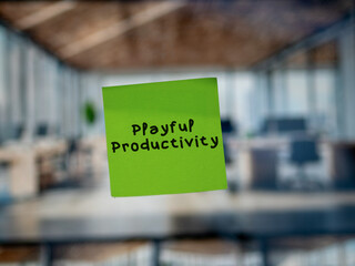 Post note on glass with 'Playful Productivity'.
