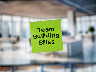 Post note on glass with 'Team Building Bliss'.