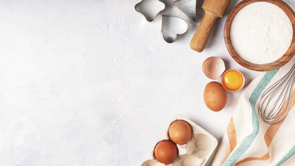 Ingredients for baking  - flour, wooden spoon, eggs.