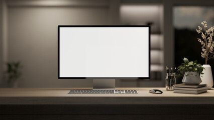 A computer desk in a modern room with a dim light, a PC computer white-screen mockup.