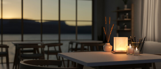 A table with a dim light from a table lamp in a contemporary romantic restaurant at night.