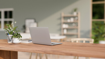 A back view of a laptop computer on a wooden table in a contemporary bright room. - 776916179